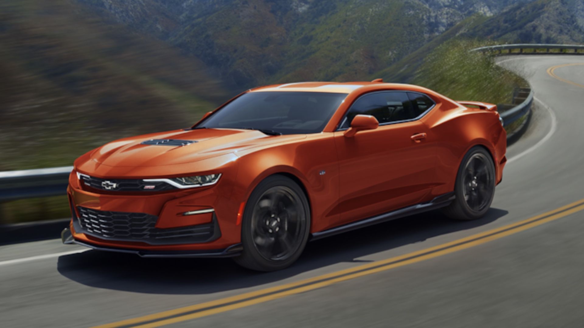 Orange 2024 Chevrolet Camaro front view driving