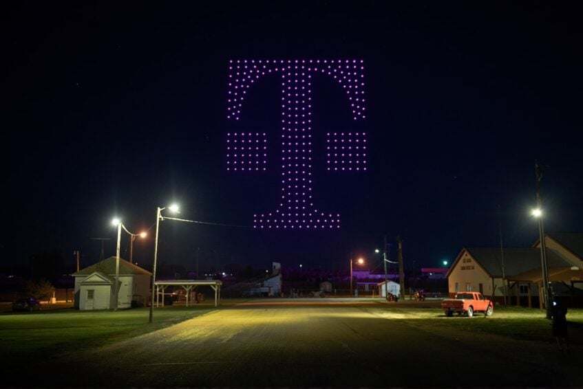 T-Mobile logo illuminated in the sky