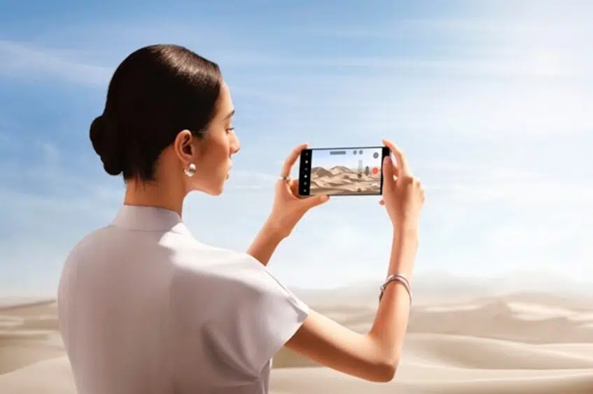 Woman taking photo in desert with Oppo Find X8 Pro phone