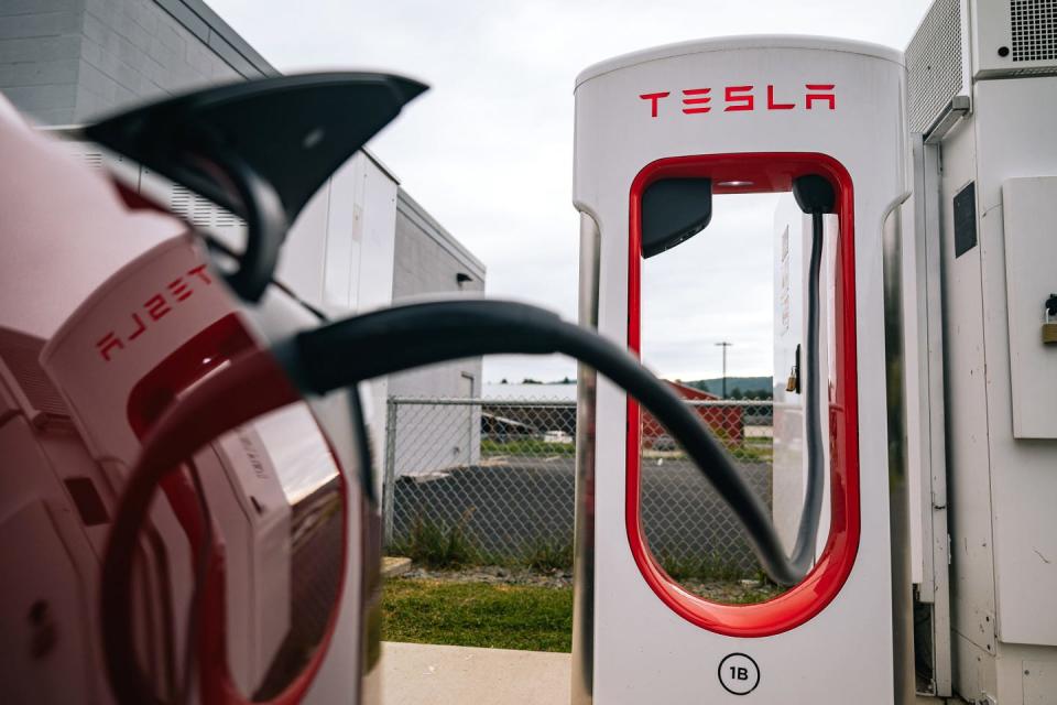 tesla electric vehicle charging station with a visible charging plug