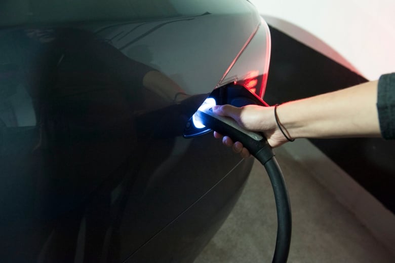 A Tesla car gets charged at a station in the parking lot of Toronto's Yorkdale mall.