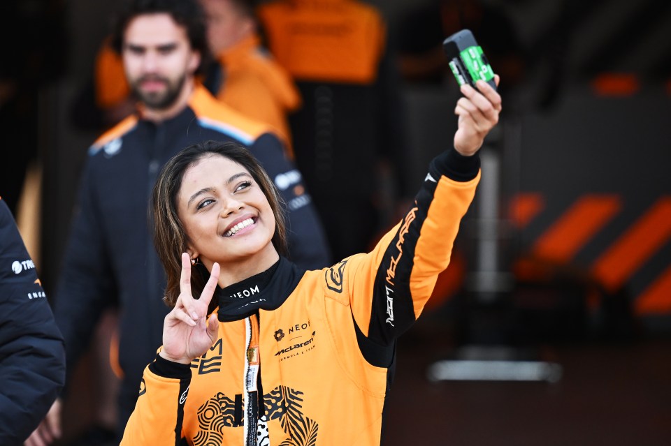 Bianca Bustamante makes a peace sign with her hand as she takes a selfie during day four of Formula E Pre-Season Testing at Circuito del Jarama on November 08, 2024