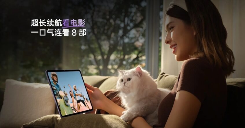 Smiling woman with holding cat in one hand and the Oppo Pad 3 in another hand