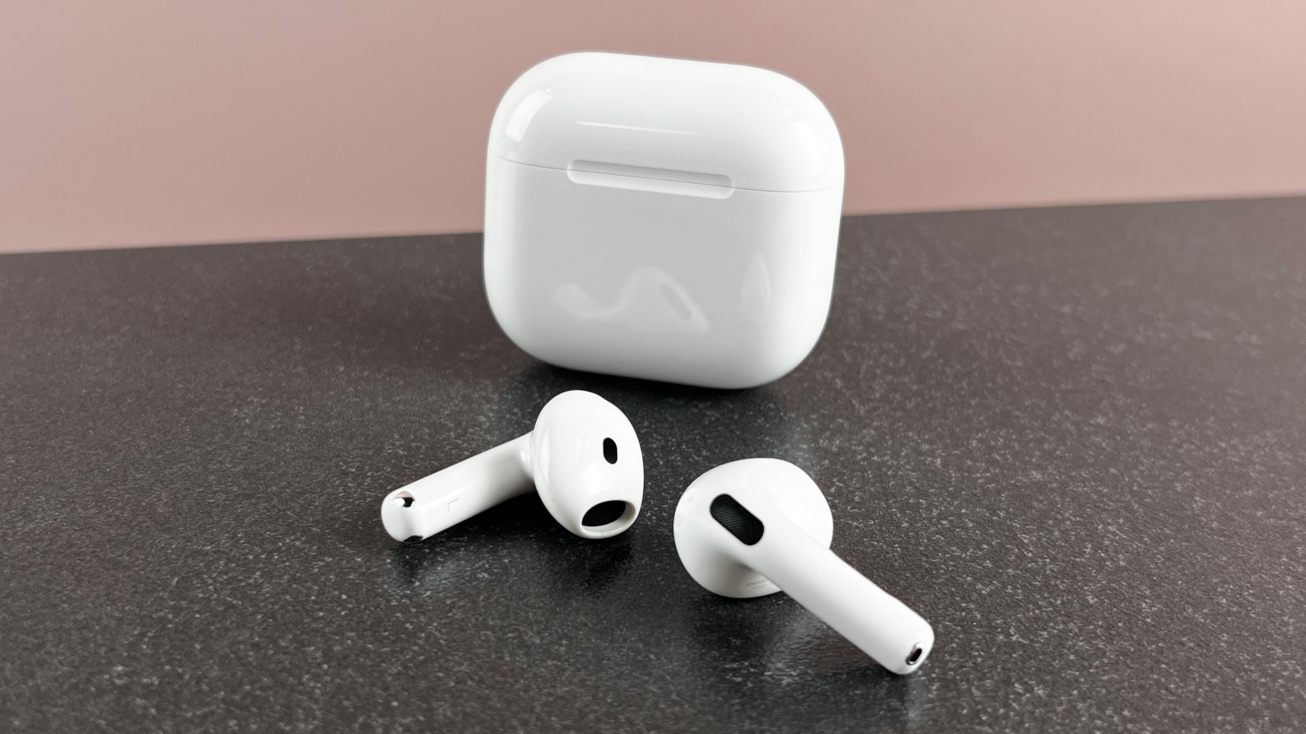 AirPods 4 outside of their case on a table