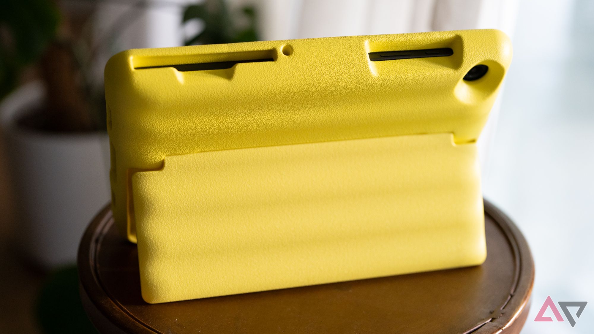 A yellow table case in kickstand mode on a table