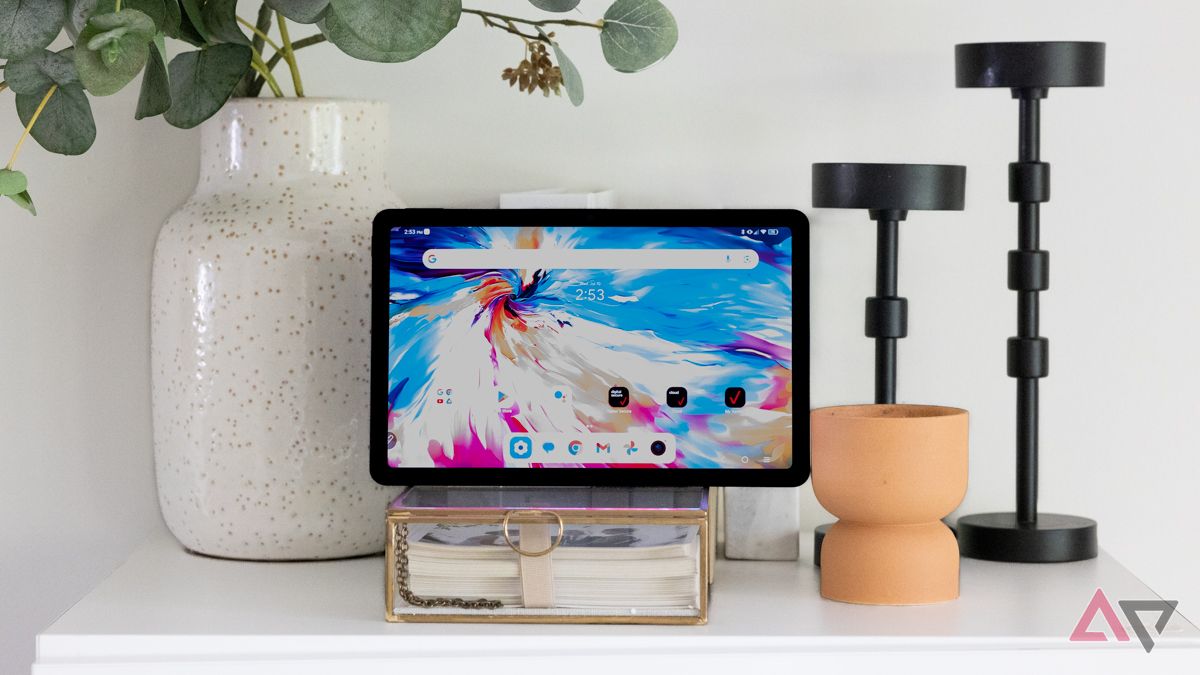 A TCL Tab 10 NXTPAPER 5G next to plants and candle sticks