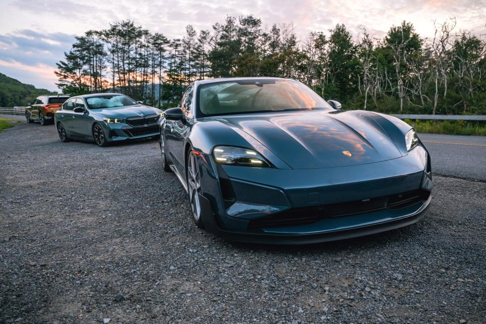 porsche taycan turbo gt, bmw i5 m60 xdrive, and acura zdx type s parked along a gravel roadside during sunset