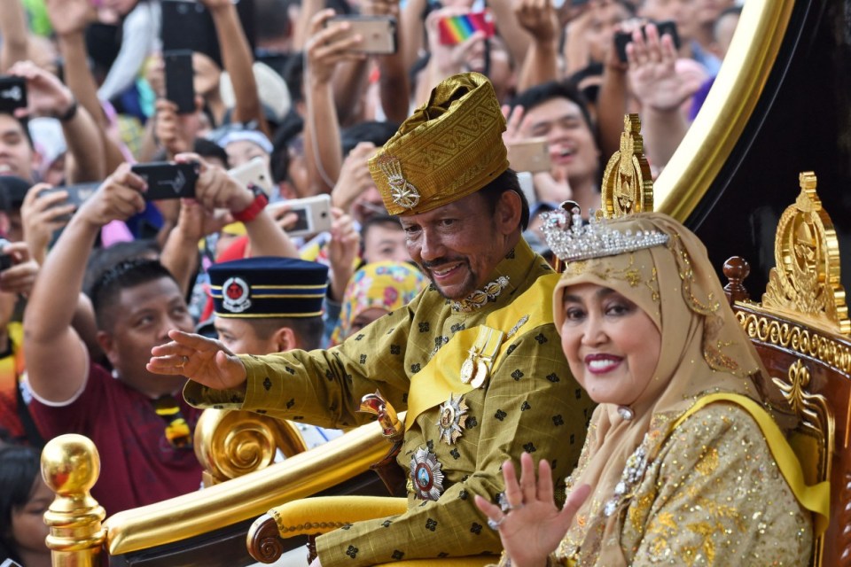 Sultan Hassanal Bolkiah, the owner of 7,000 cars, with his wife