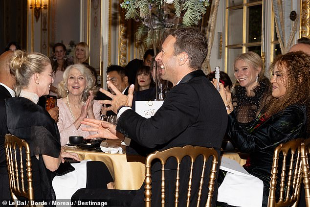 Pictured: Apple Martin's father Chris Martin, the lead singer of Coldplay, seen at his family's table at the event