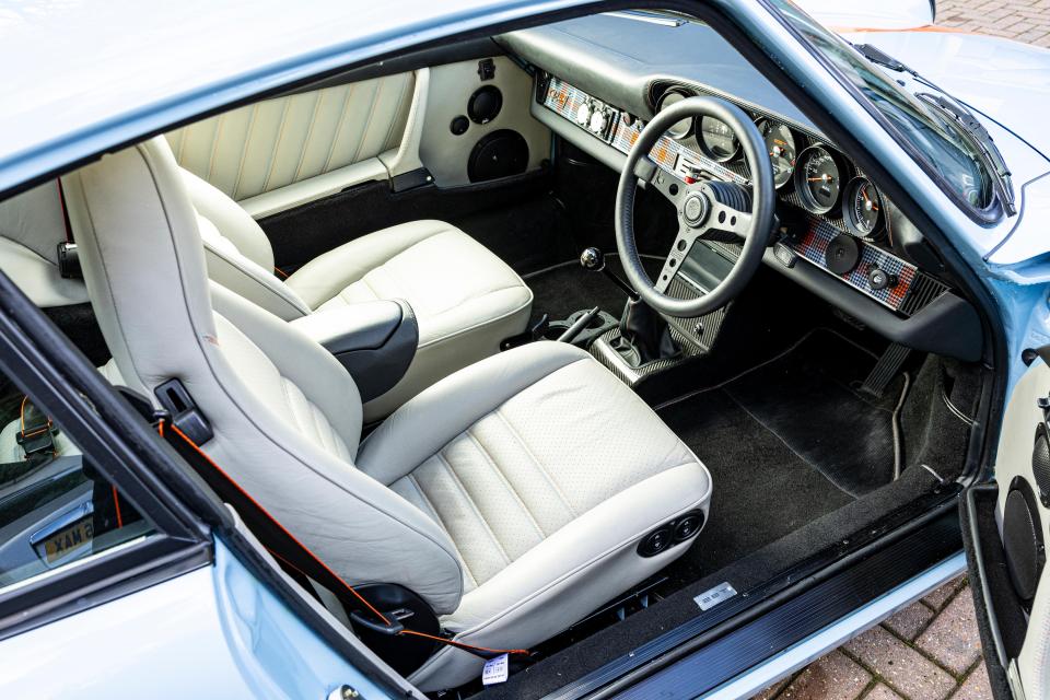 It has a MoMo Prototipo Black Edition steering wheel and a leather-trimmed dashboard top-roll