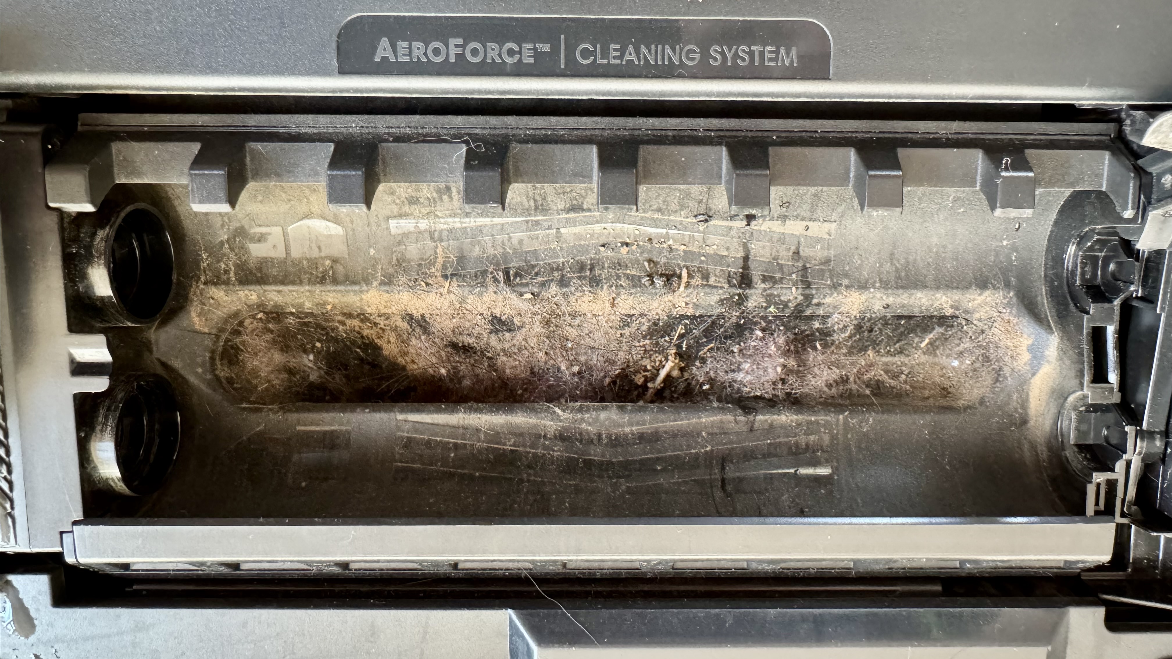 Suction inlet on iRobot Roomba Combo 10 Max clogged with damp dust and debris after vacuuming and mopping simultaneously