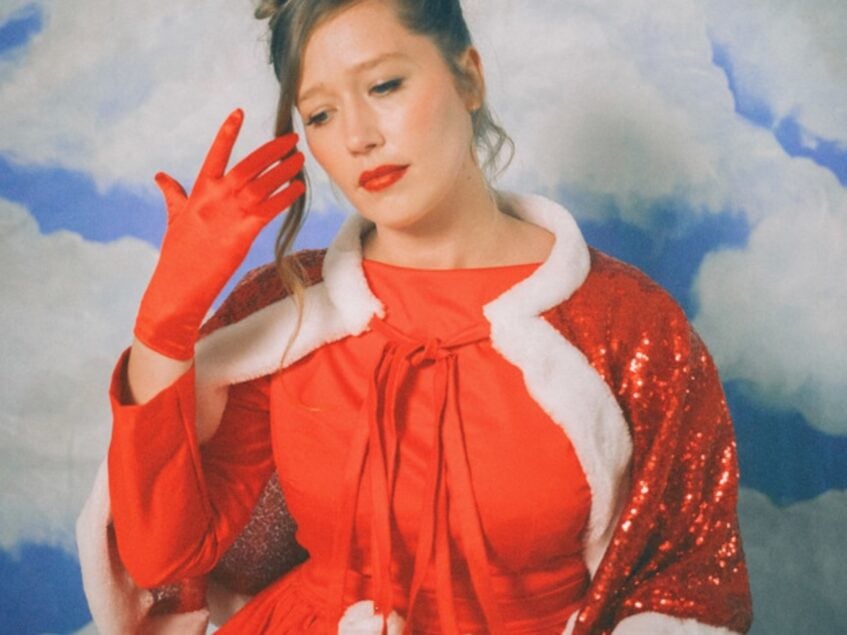 Julia Jacklin in red Christmas dress and gloves