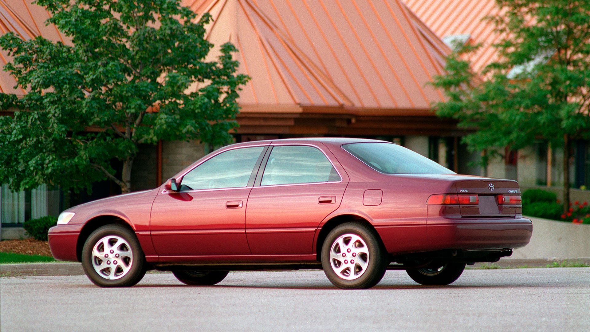 Red 1997 Toyota Camry on road