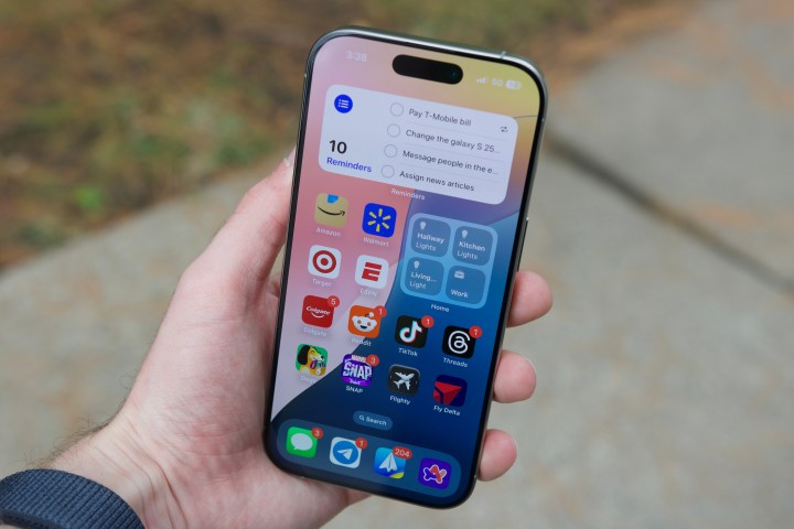 Someone holding the iPhone 16 Pro, showing the home screen.