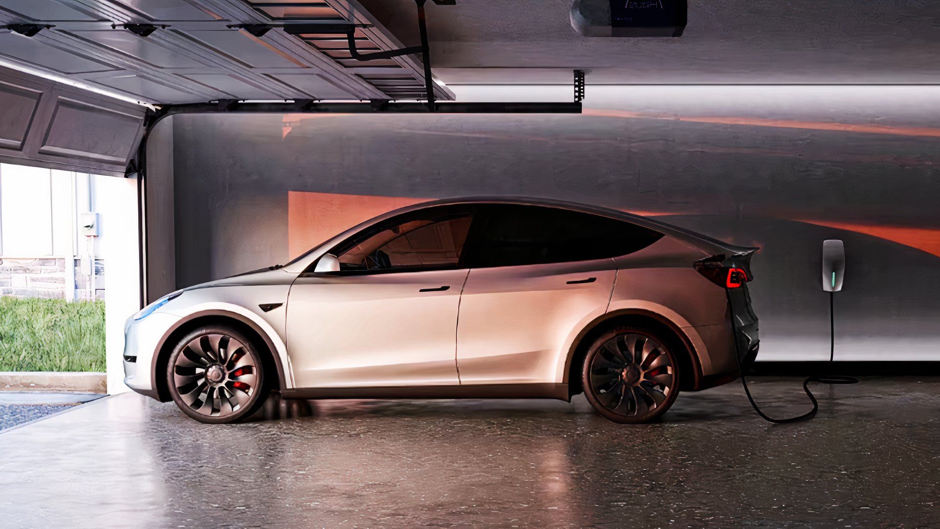 A gray Tesla Model Y small electric SUV is parked.