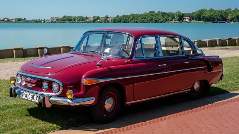 Red Tatra 603 parked by the water