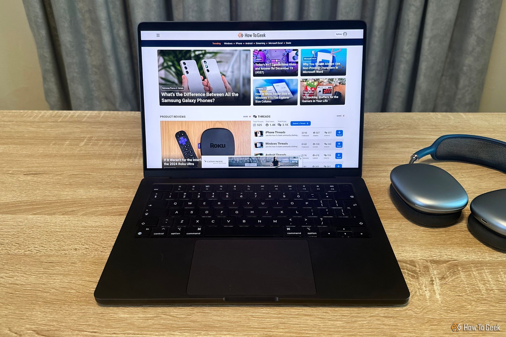 M4 Pro MacBook Pro with web browser open next to AirPods Max.