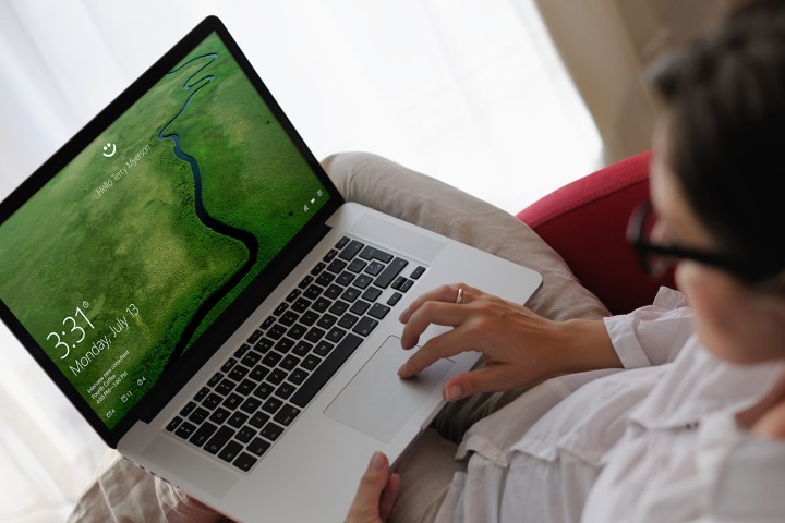 A person using a laptop with Windows Hello.