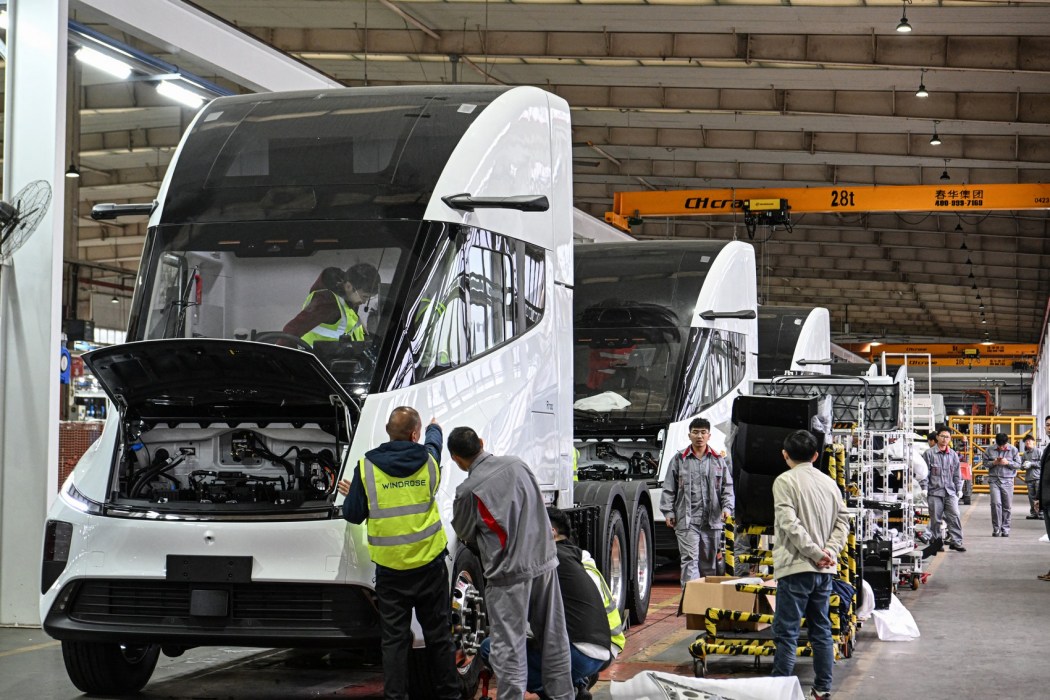 Employees of Chinese electric truck startup Windrose working on an electric truck assembly line at a factory in Suzhou, in eastern China's Jiangsu province, on  November 18, 2024. Photo: AFP/China Out. 