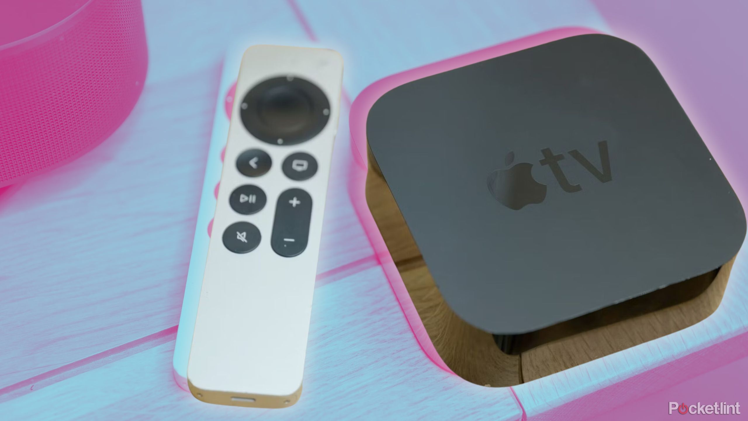 An Apple TV 4K and a Siri Remote on a table.