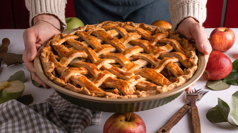 Holding a fresh baked apple pie