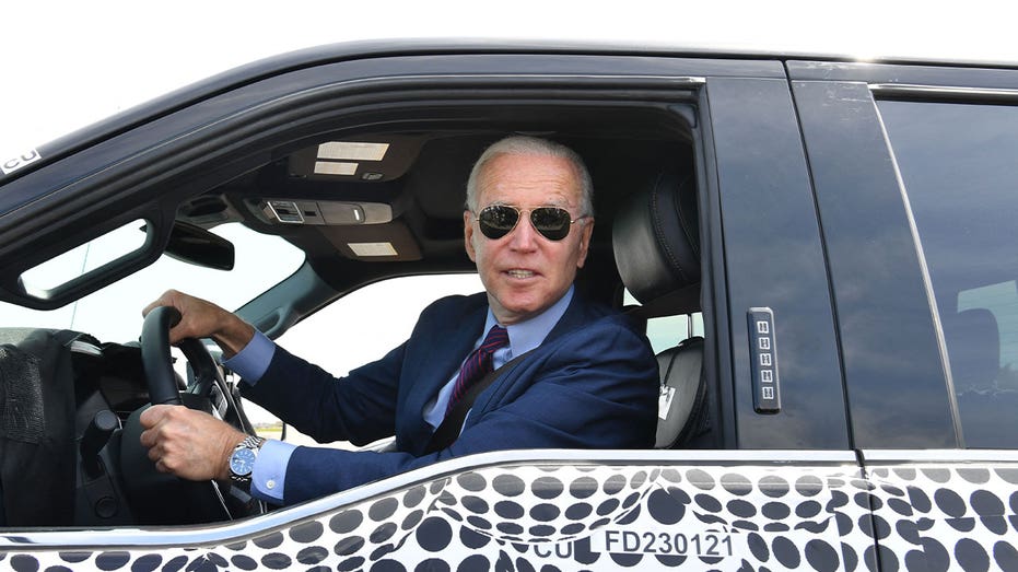 President Joe Biden sits inside a Ford electric vehicle during tour of plant