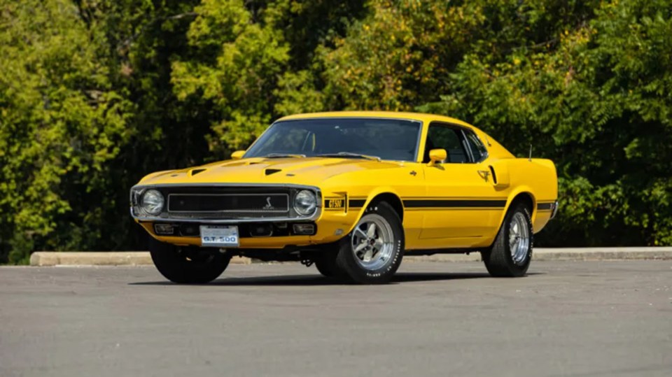 The Ford GT500, once owned by Carroll Shelby, is painted bright yellow with an eye-catching black stripe