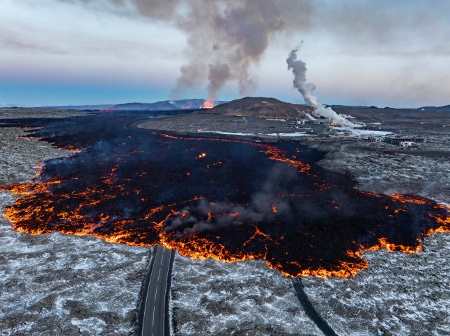 CORRECTS POSITION OF LAGOON AREA -Panoramic view of the eruption site with the Blue Lagoon area to the right and the active fissure in the far background after the volcanic eruption that started Wednesday, on the Reykjanes Peninsula in Iceland, Thursday, Nov.21, 2024. (AP Photo/Marco di Marco)