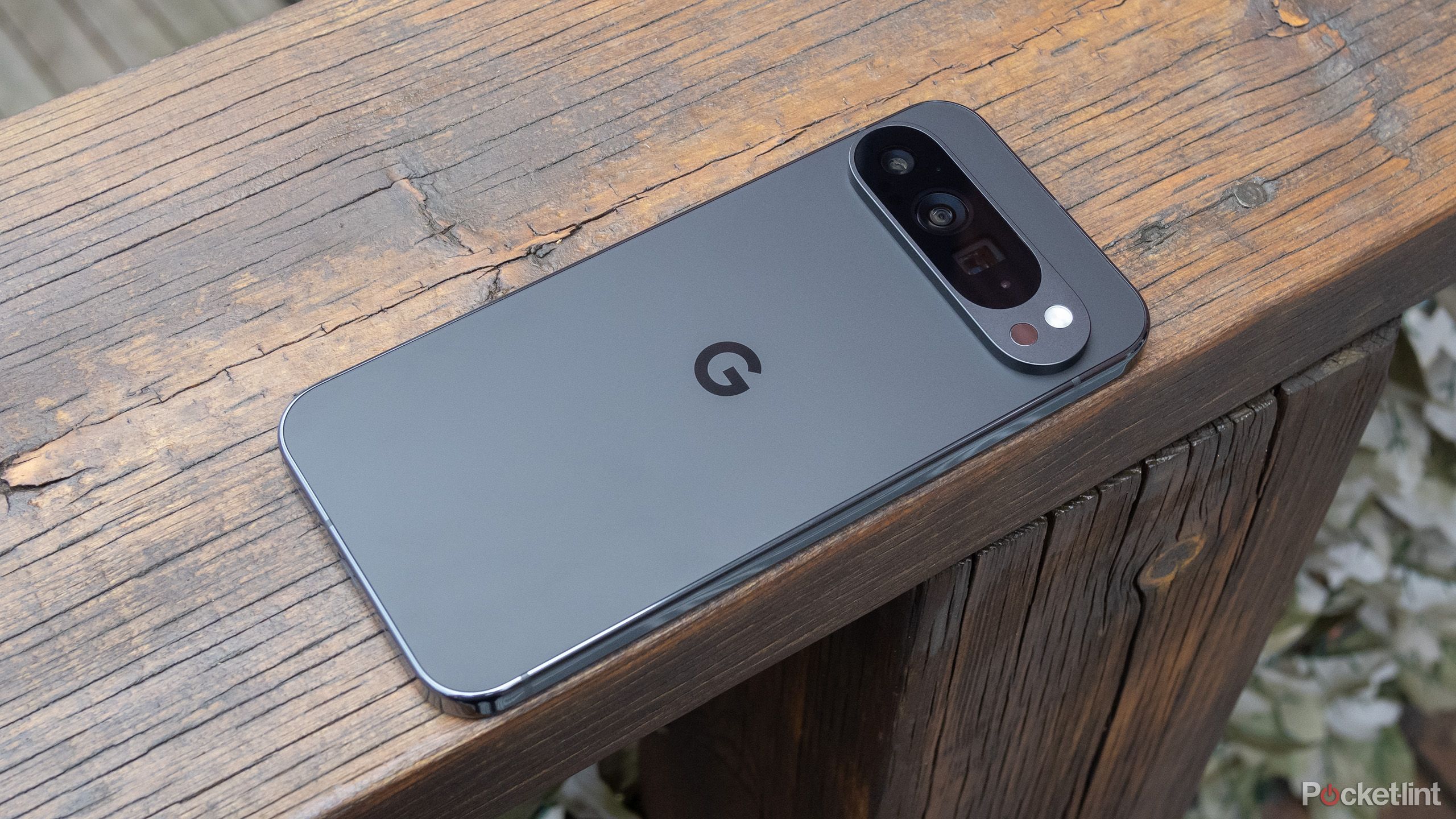 The Pixel 9 Pro Xl sitting screen-down on wood