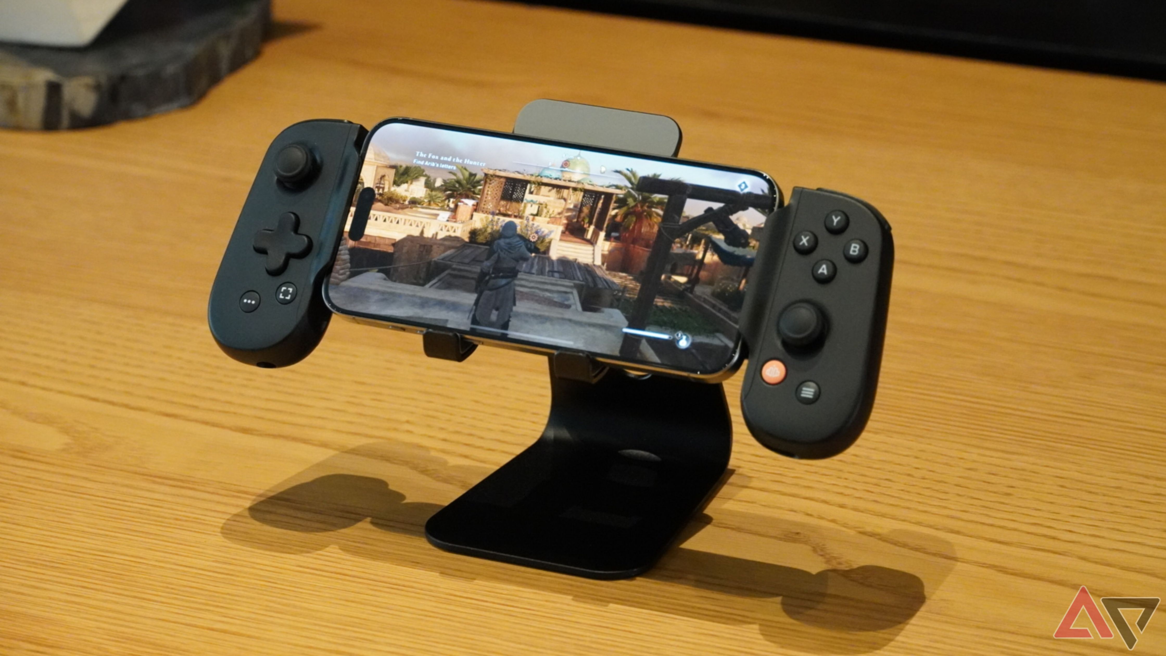 An iPhone playing a game with a mobile controller.