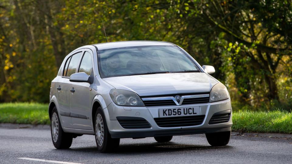 Silver Vauxhall Astra driving on a road.