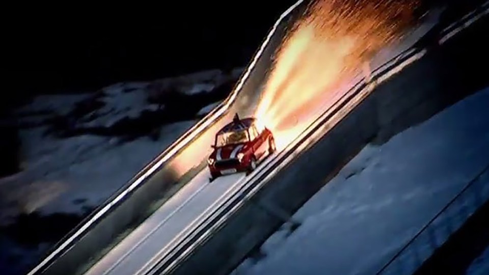 Mini Cooper rocket-powered down ski jump.