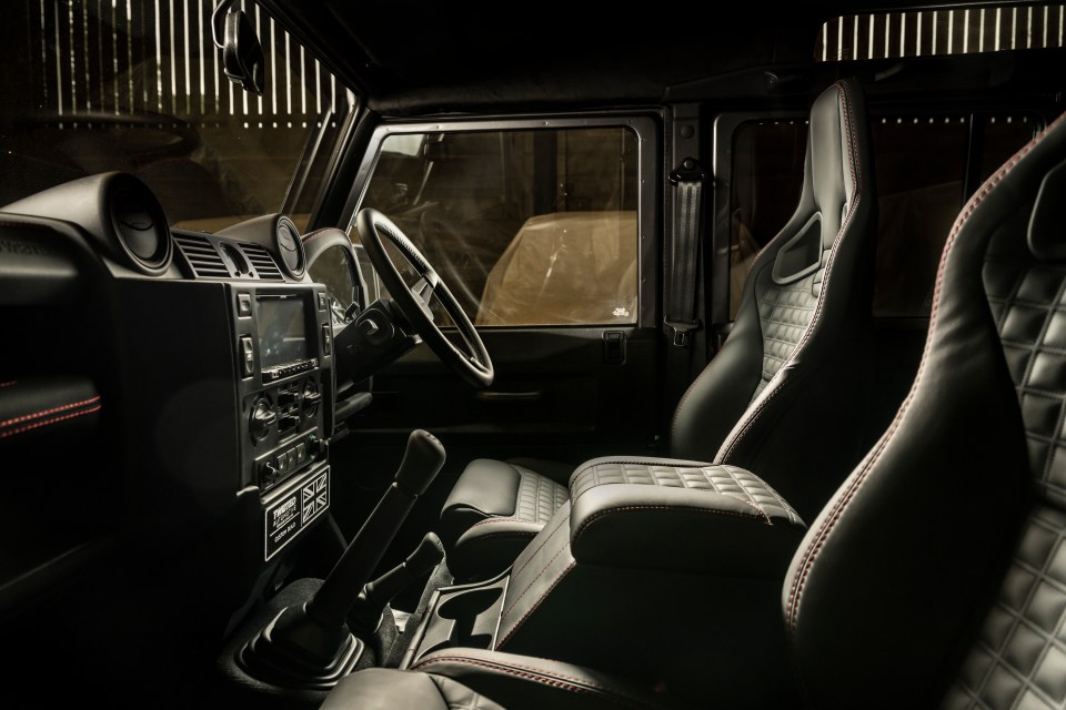 Interior of a Land Rover Defender with custom leather seats.