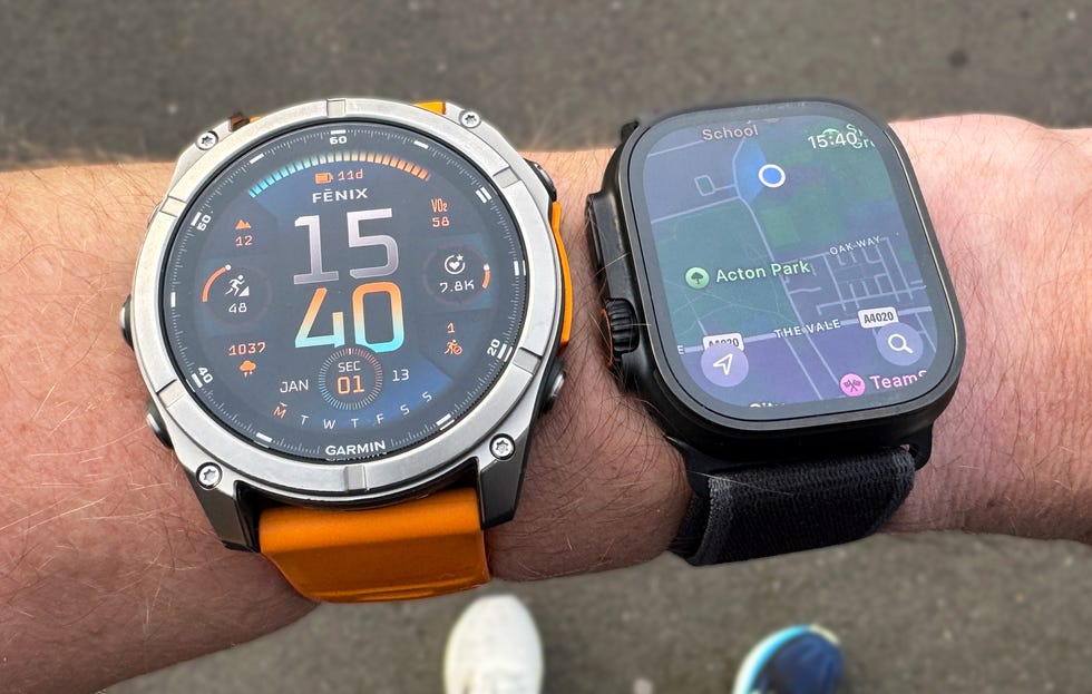 two smartwatches on a person's wrist