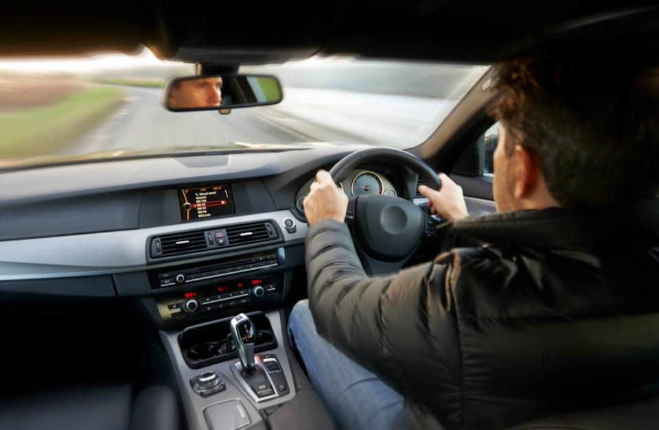 Man driving a car.