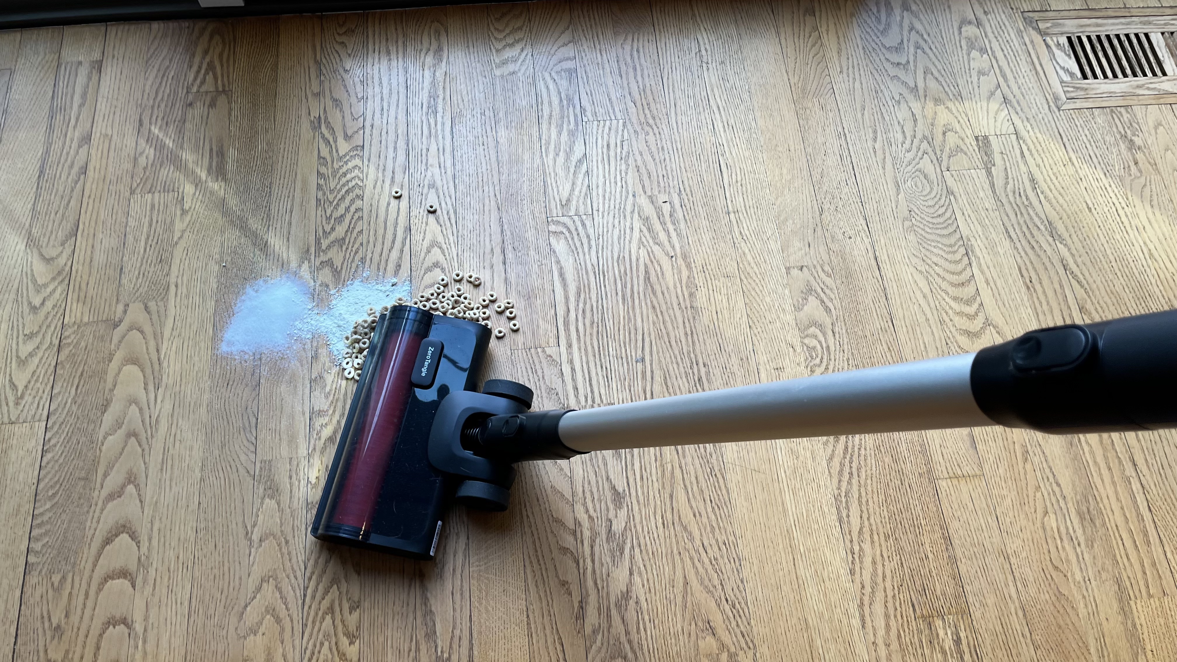 Yeedi C12 Combo stick vacuum cleaning up cereal, sugar, and flour