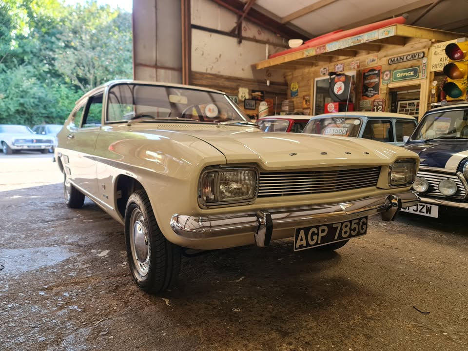 Cream-colored Ford Capri in a garage.