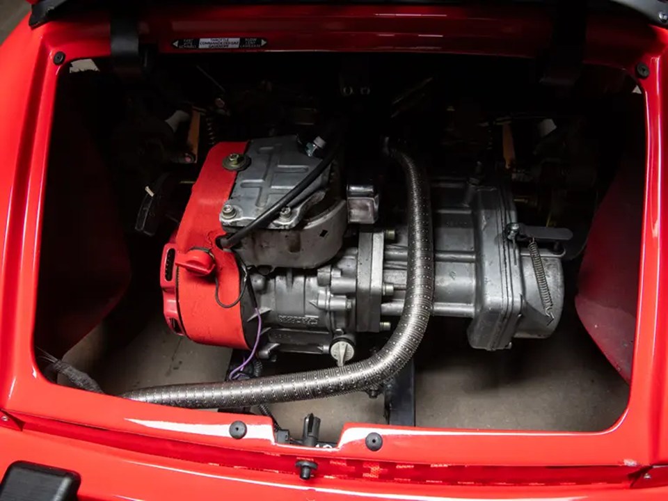 Engine of a red Porsche 911 Junior children's car.