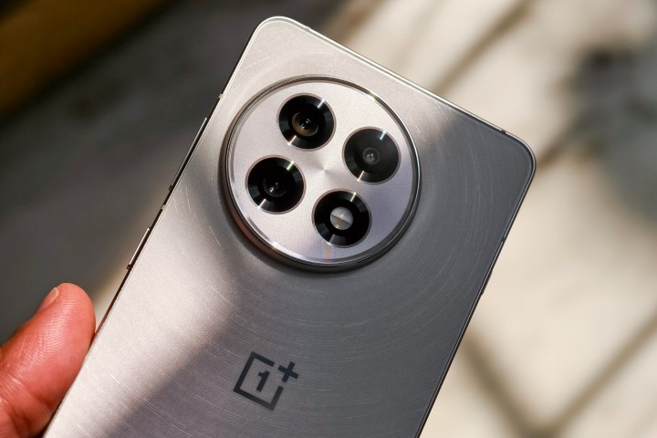 Camera module on the OnePlus 13R white held in hand. 