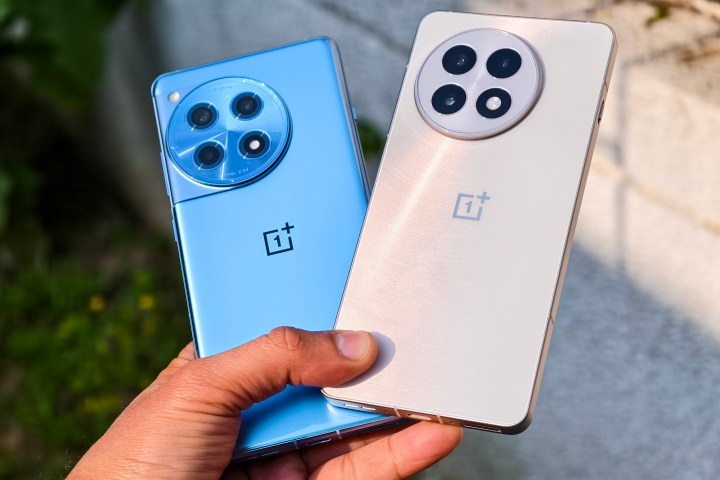 White OnePlus 13R and blue OnePlus 12R held together in hand. 