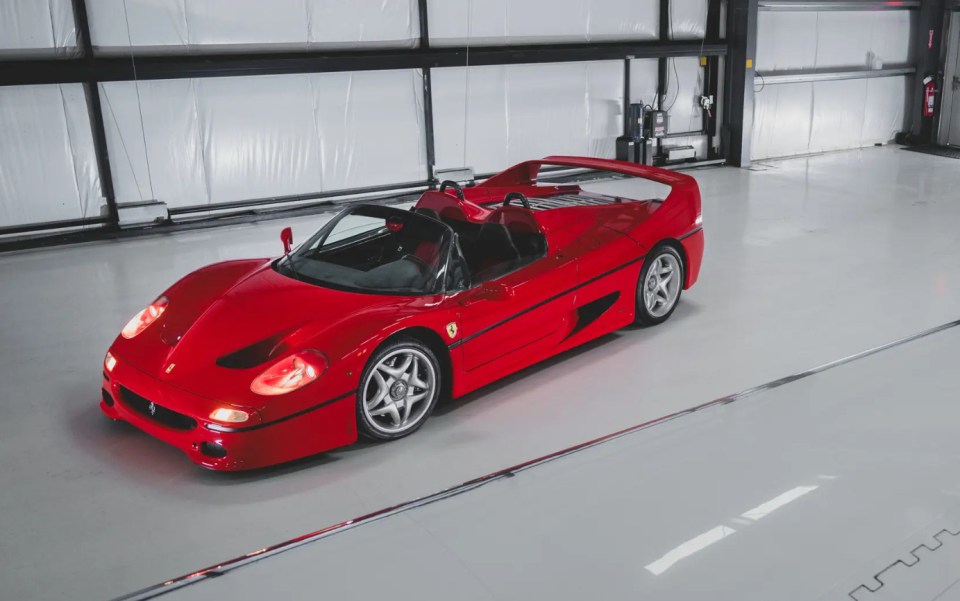 Red Ferrari F50 in a garage.