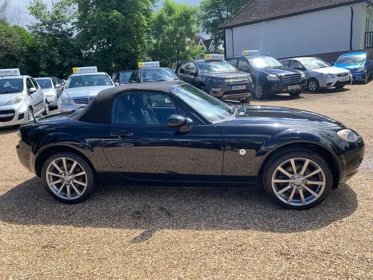 Black Mazda MX-5 convertible.