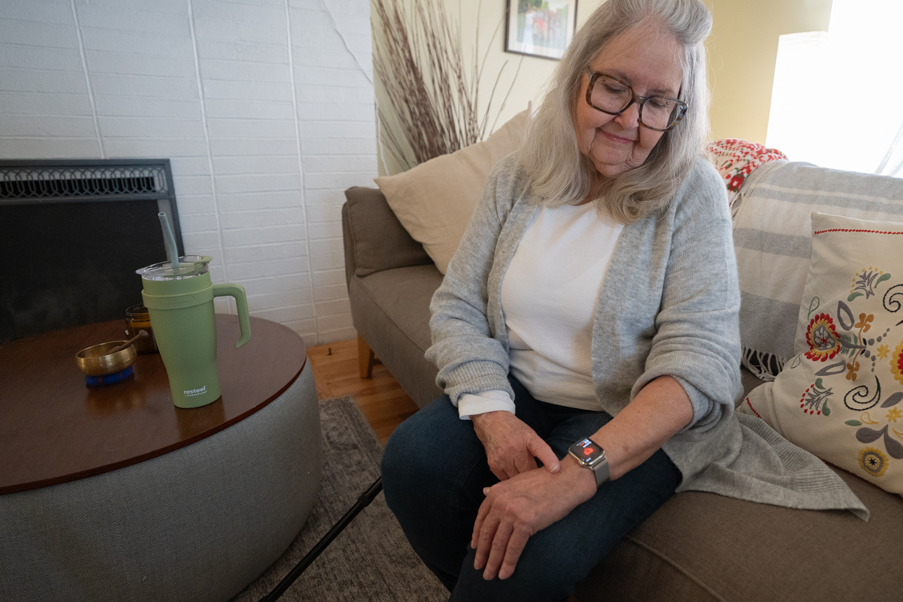 An old woman tracking her health on a smartwatch.