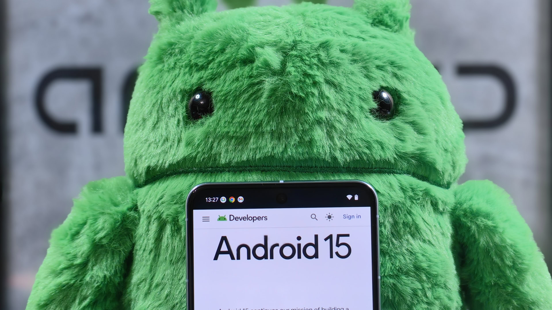 Pixel 8 Pro in front of an Android plushie