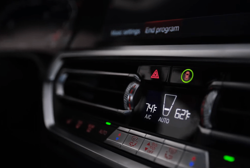 BMW car interior climate control panel showing temperature settings.