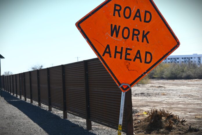 Work was still being done on a new corrugated metal wall along the eastern side of Maricopa-Casa Grande Highway around 11:30 a.m. Jan. 30, 2025. [Elias Weiss]