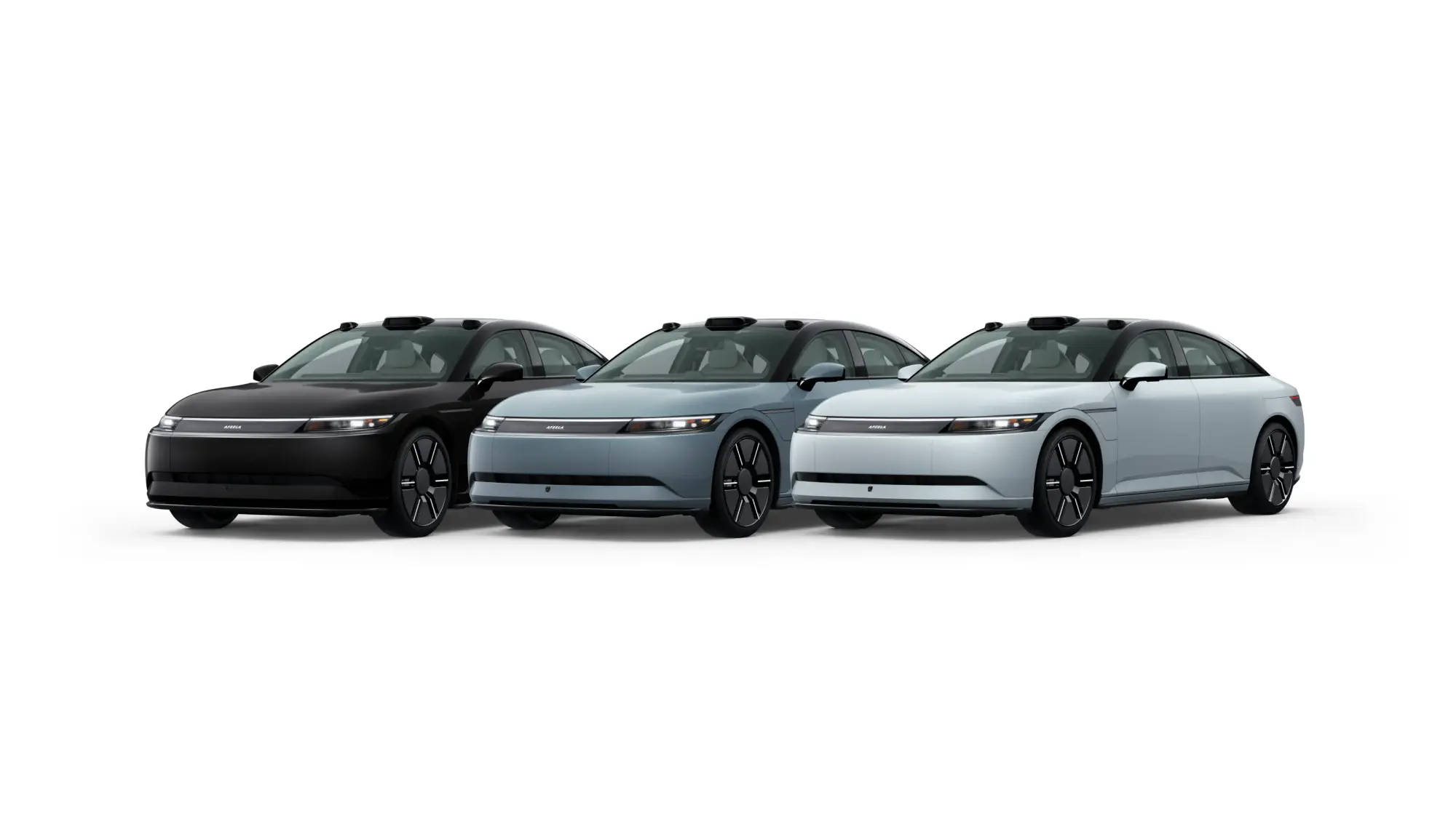 A lineup of three AFEELA electric cars in different colors (black, light blue, and white), showcasing a sleek and futuristic sedan design with uniform styling.