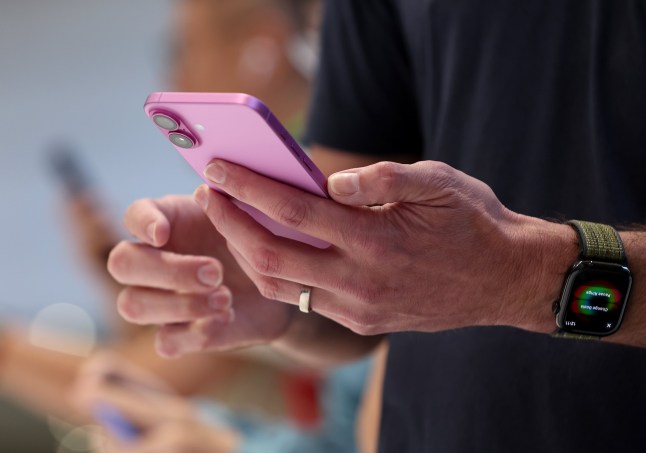 CUPERTINO, CALIFORNIA - SEPTEMBER 09: An attendee inspects the the new iPhone 16 Pro Max during an Apple special event at Apple headquarters on September 09, 2024 in Cupertino, California. Apple held an event to showcase the new iPhone 16, Airpods and Apple Watch models. (Photo by Justin Sullivan/Getty Images)