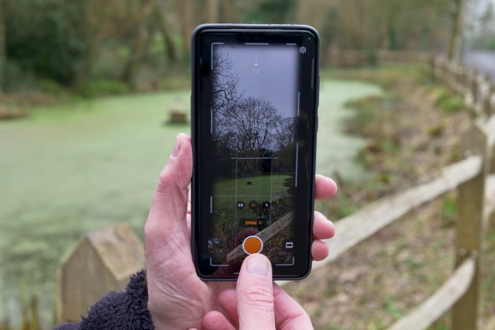 A person using the XPan mode on the OnePlus 13.