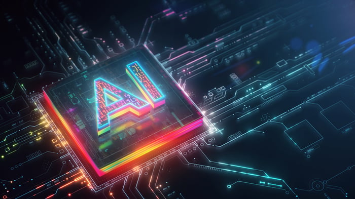 A circuit printed with leads heading to a chip and a holographic label reading AI.